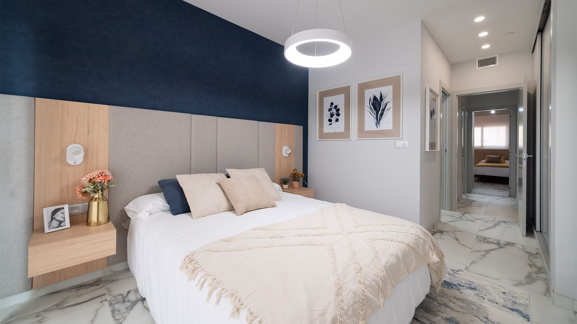 Bedroom with blue accent wall and double bed