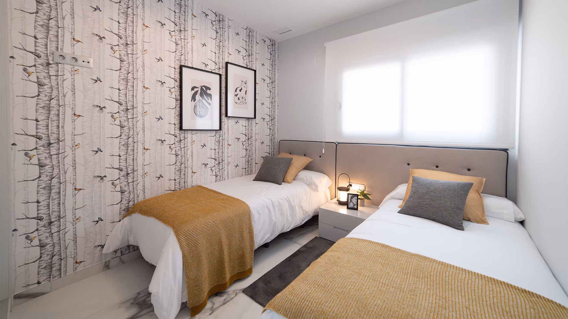 Twin bedroom with birch-print wallpaper