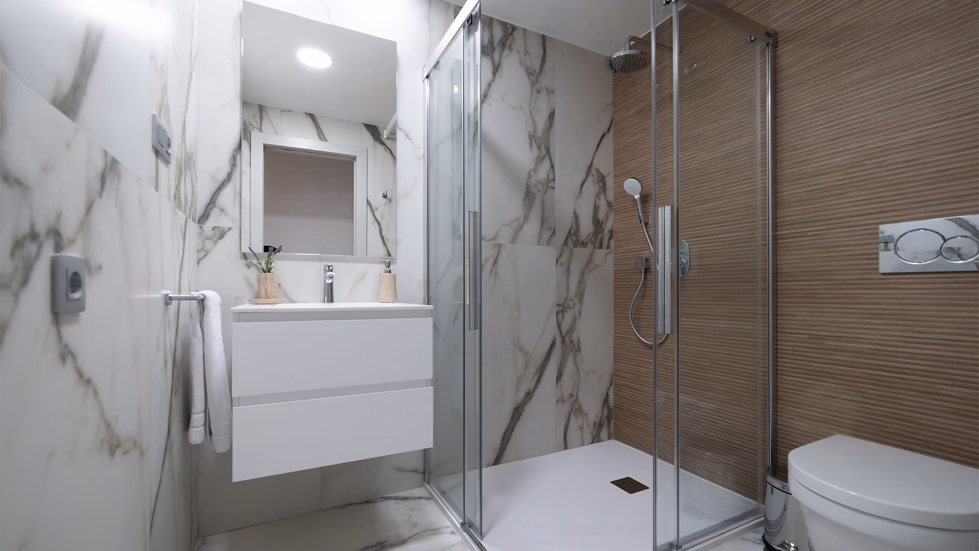 Bathroom with marble-effect tiles and glass shower screen