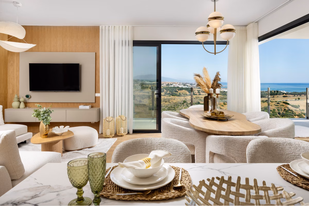 Living room with TV wall and dining table by the window