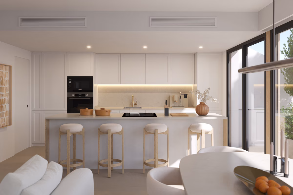 Kitchen with island and bar stools in a Torre Biznaga apartment