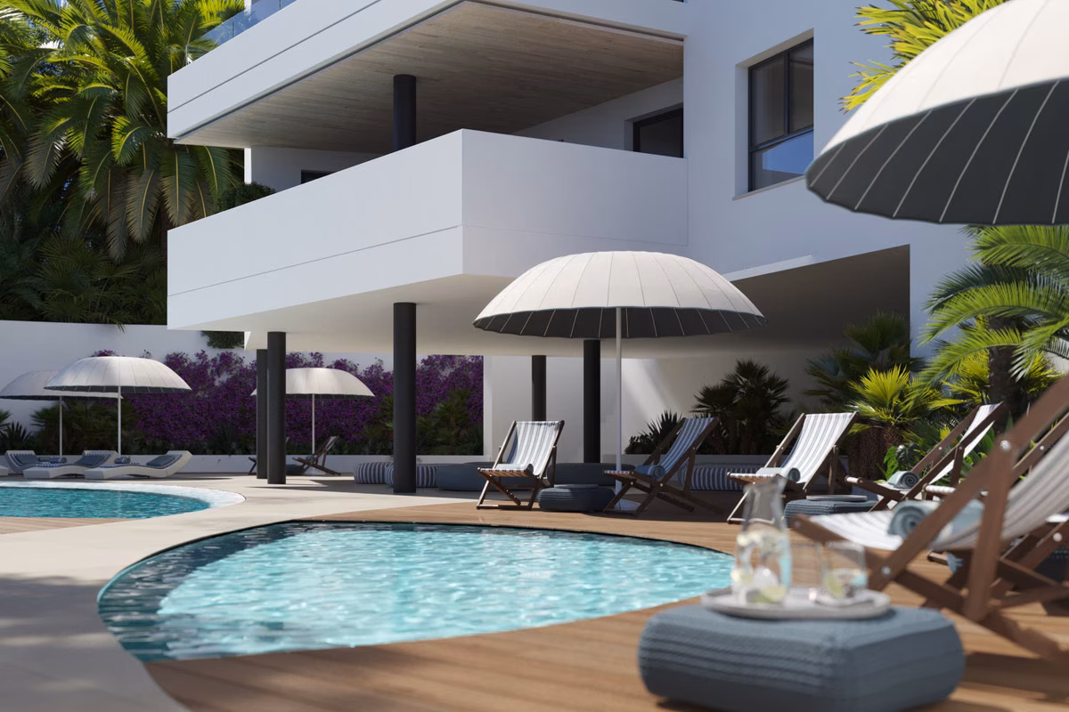 Outdoor pool with parasols and loungers in the gardens of Torre Biznaga