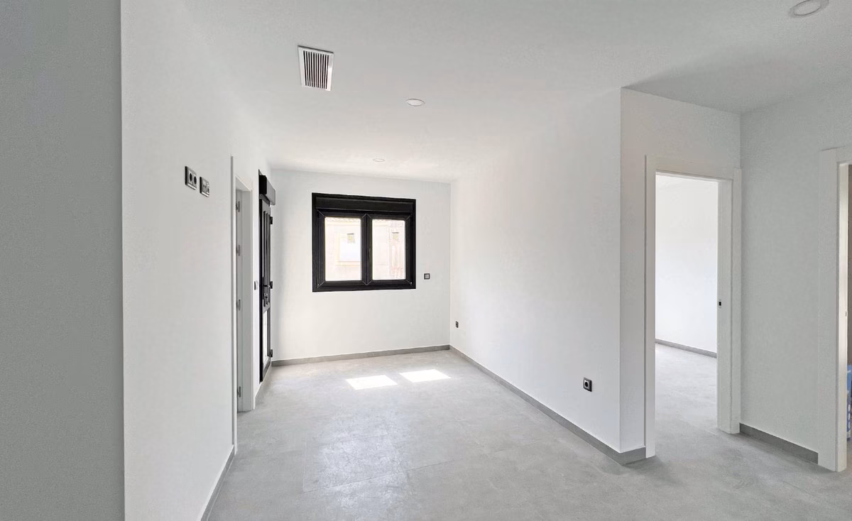 Bedroom with window and doors to the adjoining rooms