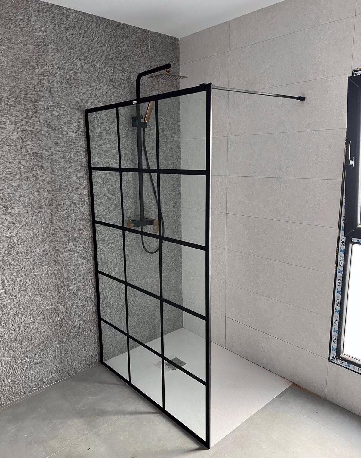 Walk-in shower with black-framed glass screen