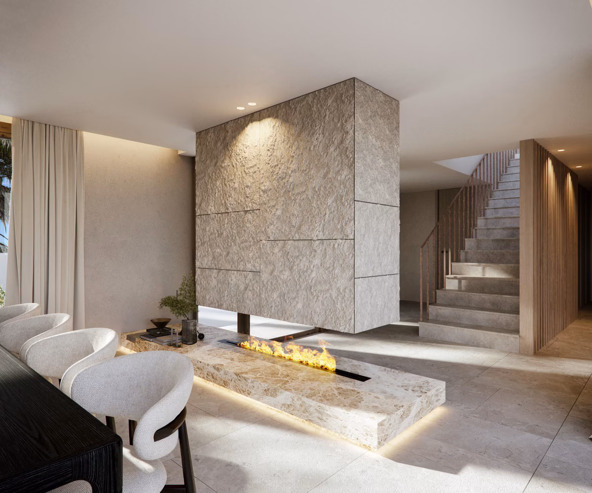 Living area with stone fireplace and staircase in a Verdana villa