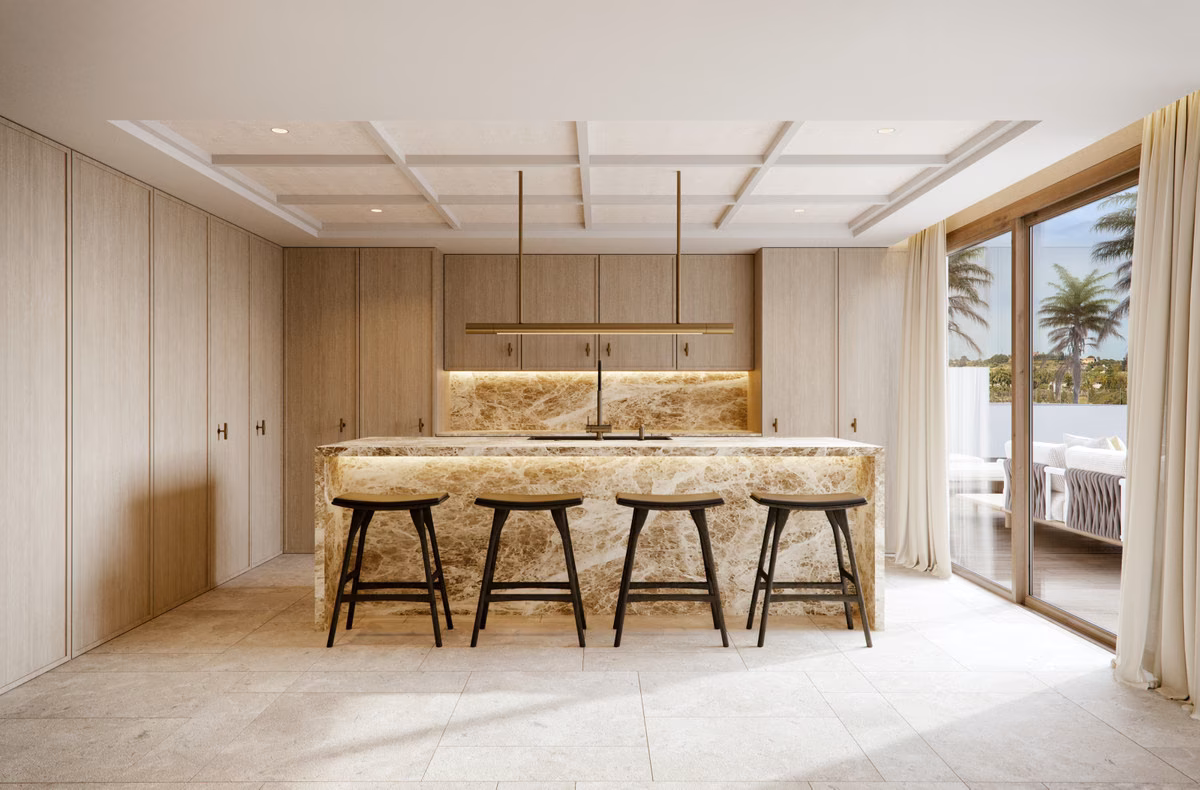 Kitchen with marble island and bar stools in a Verdana villa