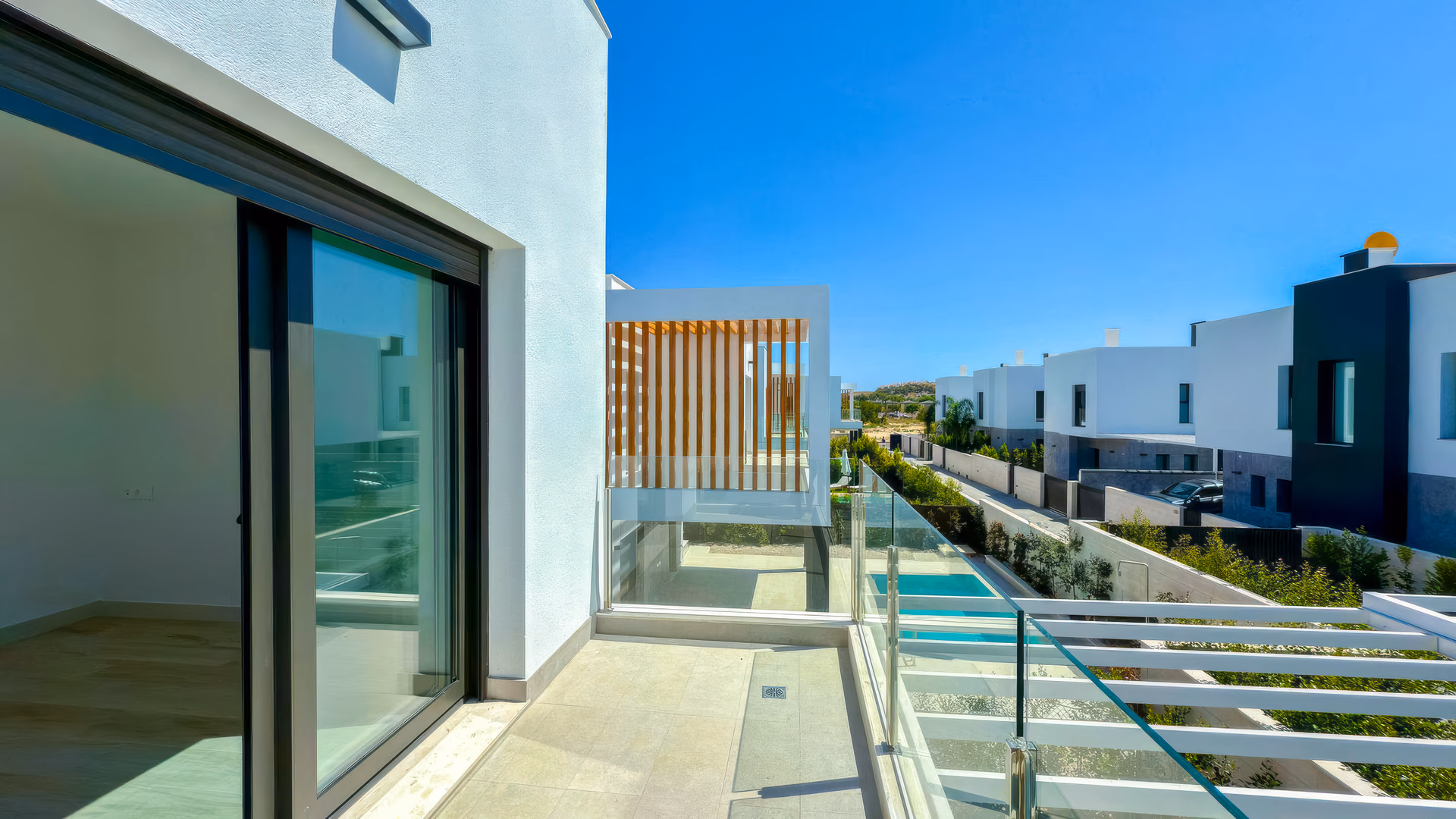 Obere Terrasse mit Blick auf den Pool und die Wohnumgebung