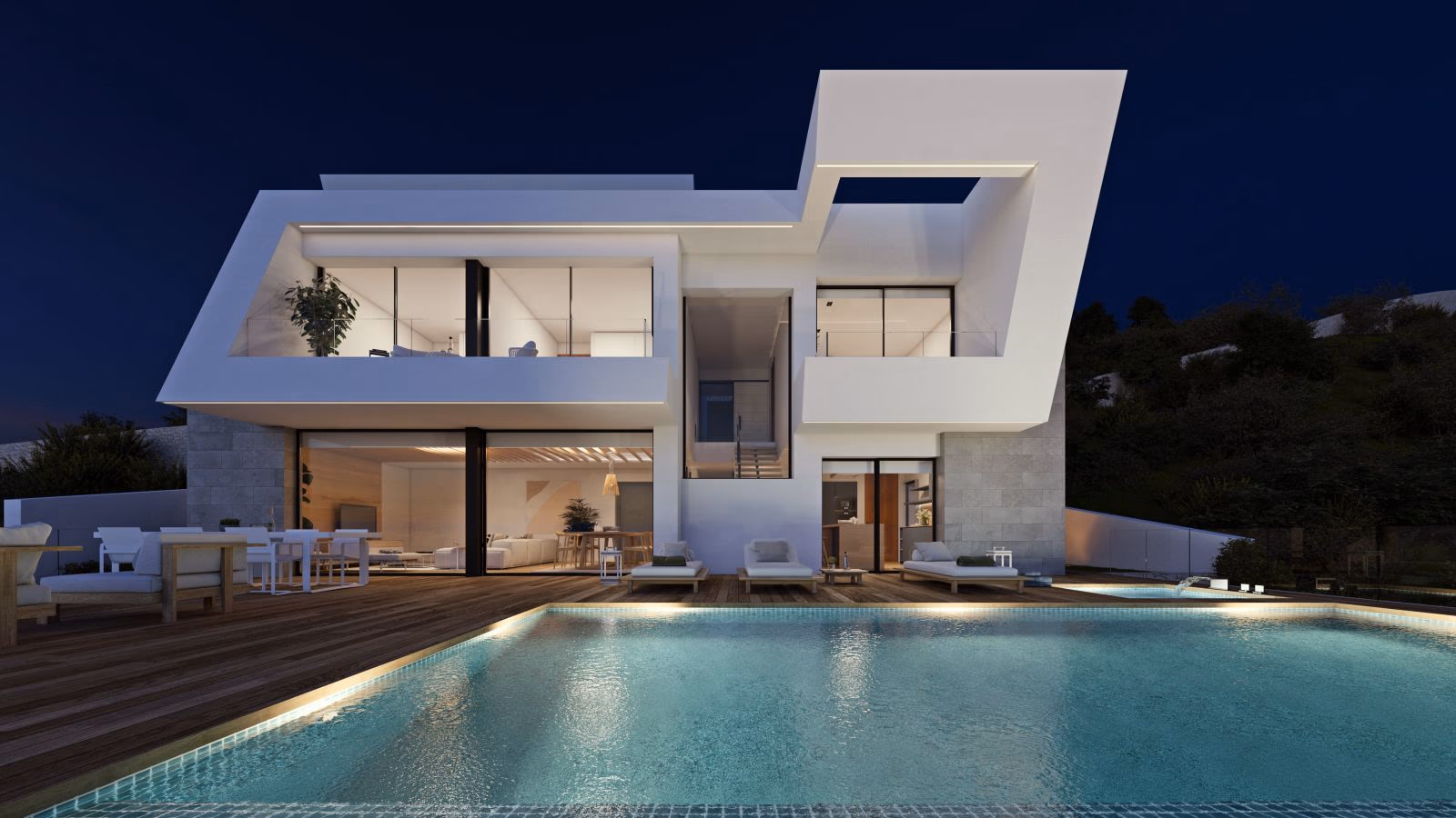 The villa illuminated at dusk with its infinity pool