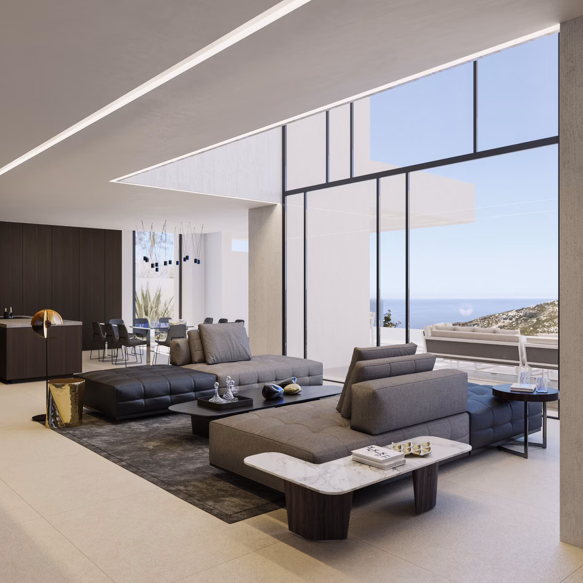 Salón a doble altura con pared de cristal orientada al mar