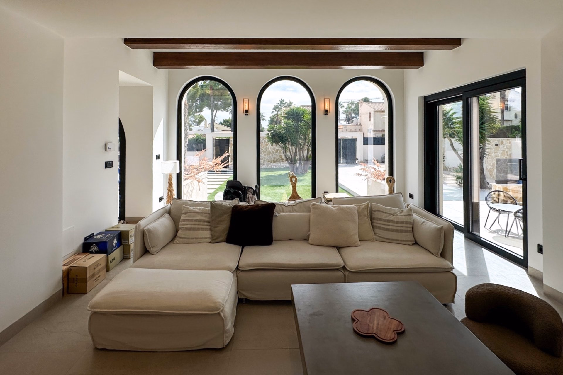 Living room with a large corner sofa and three arched windows
