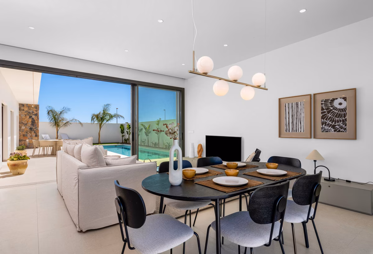 Dining table and living area with garden views