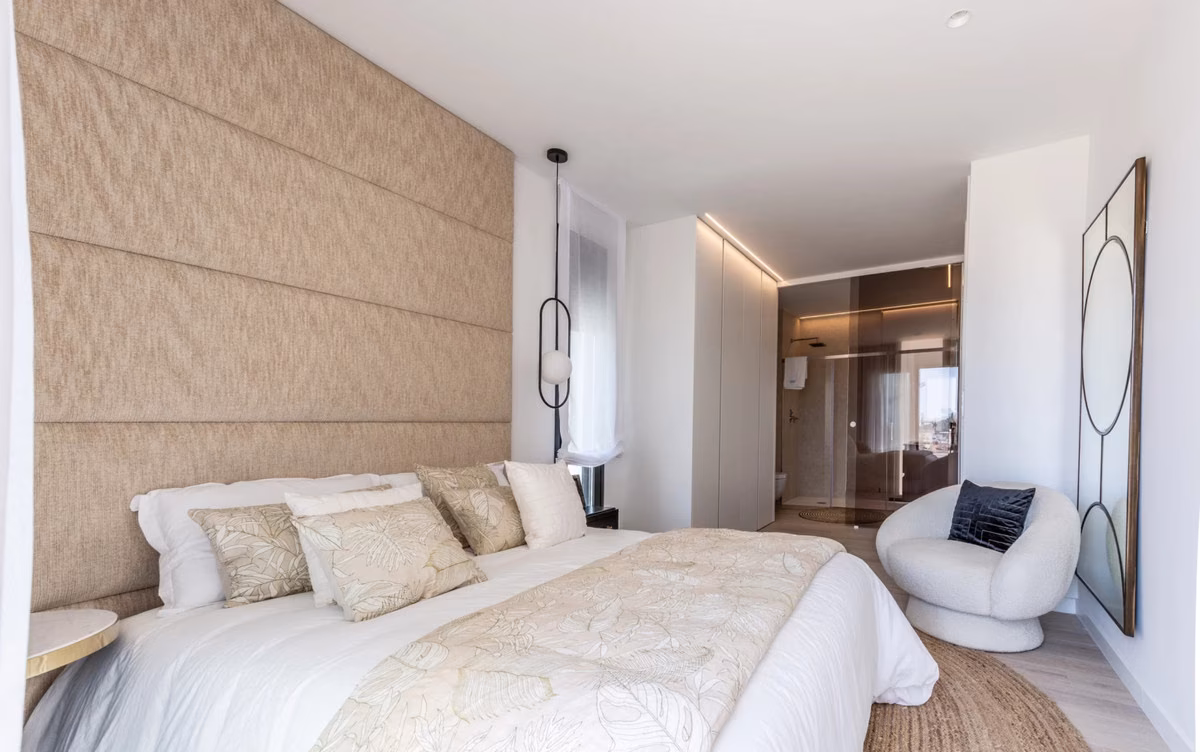 Main bedroom with an upholstered headboard wall