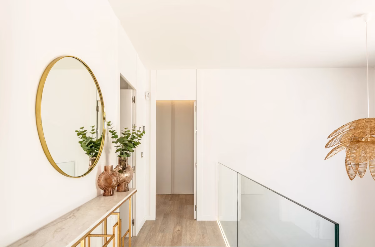 Upstairs landing with a round gold mirror