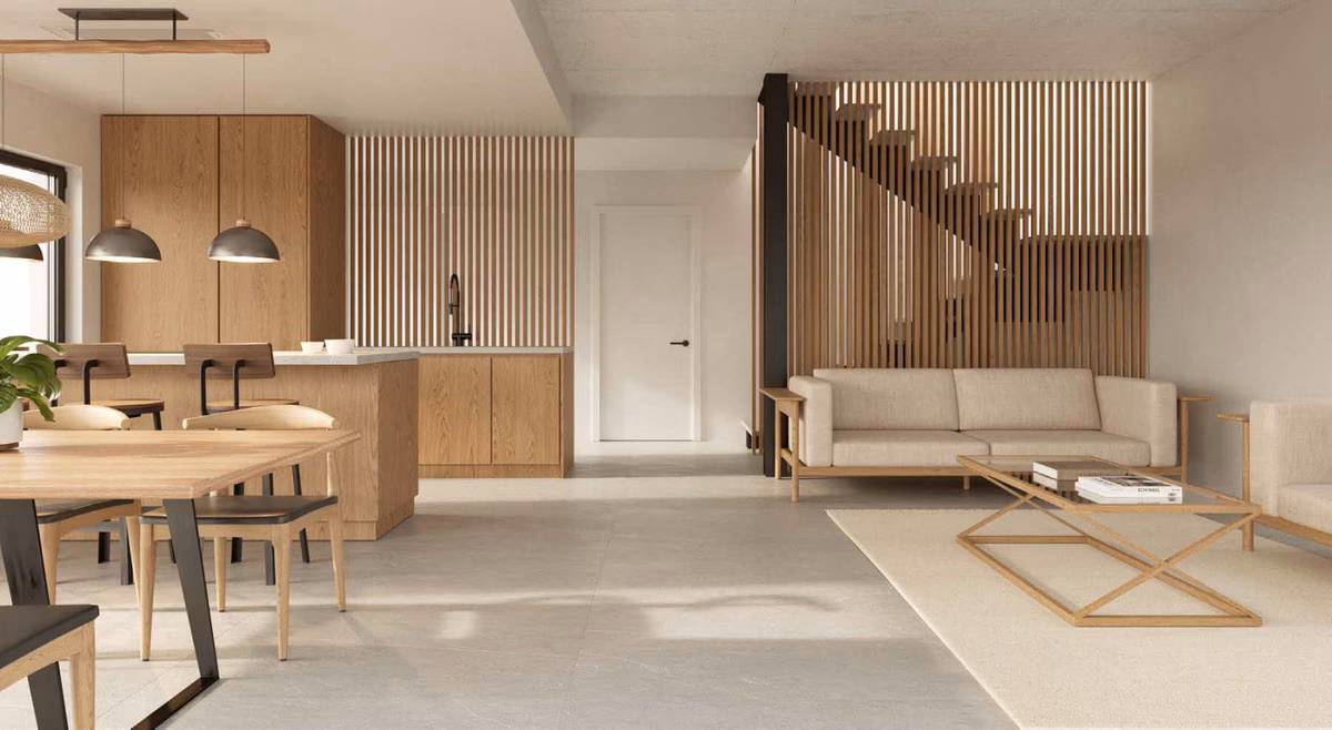 Living and dining area with oak kitchen and a staircase behind timber slats